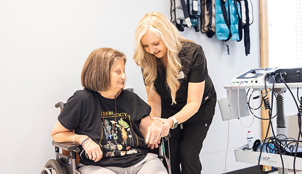 team member checking a female resident's pulse